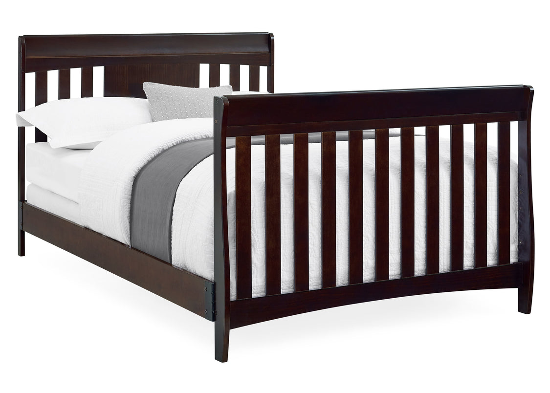 Dark wood crib with white bedding on a white background