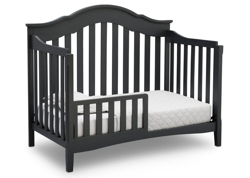 Black crib with white mattress on a white background