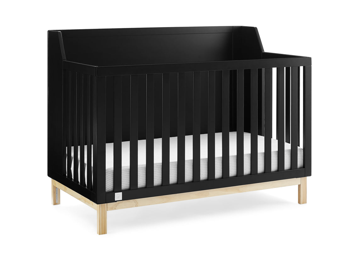 Black crib with white mattress on a white background