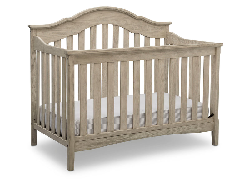 Wooden crib with a white mattress on a white background
