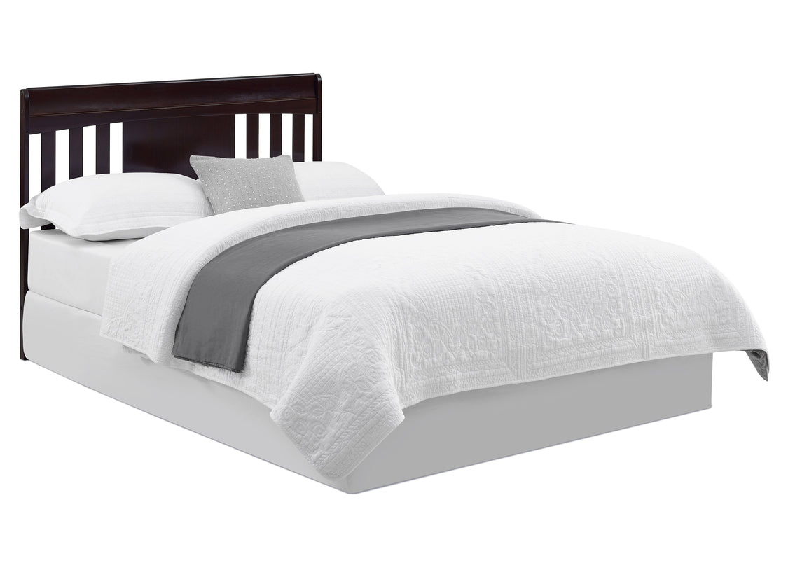Bed with white bedding and a dark headboard on a white background