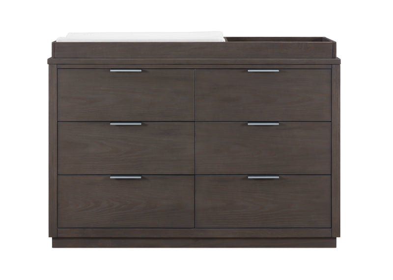 A modern six-drawer dresser in dark brown wood grain with sleek silver metal handles, featuring a white and black top surface.