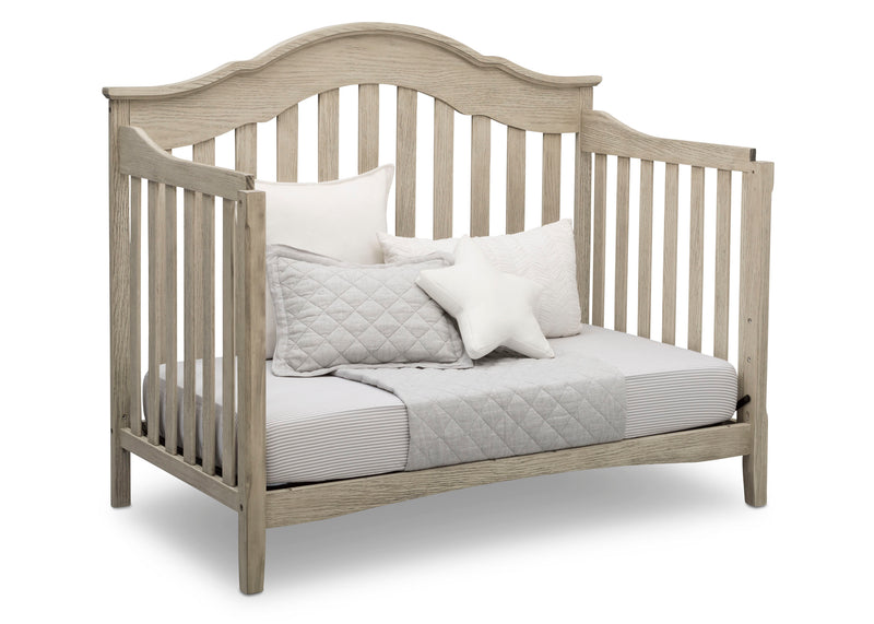 Wooden crib with bedding on a white background