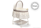 A white and beige Deluxe Sweet Beginnings Bassinet with a fitted sheet, removable canopy, storage basket underneath, and locking wheels. 1-Deluxe Sweet Beginnings Bassinet
